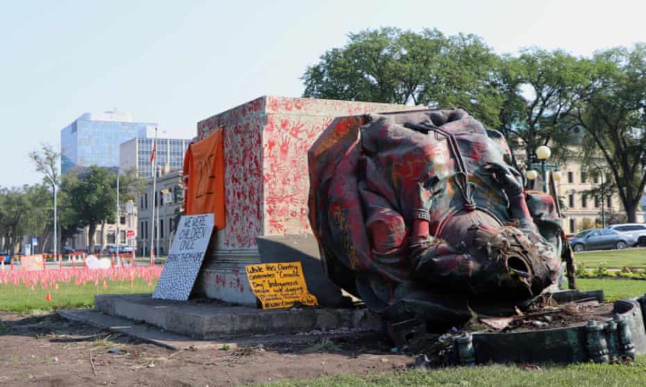 A headless statue of Queen Victoria is seen overturned at the provincial legislature in Winnipeg on Friday.