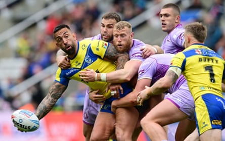 Paul Vaughan holds off a few Wigan players to set up a try for teammate Matt Dufty.