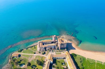 A castle on the edge of a lake, seen from above