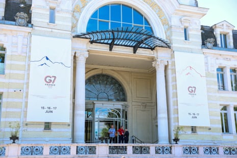 People stand outside the Palais Lumiere ahead of the G7 summit in Evian-les-Bains, France, 12 June 2026.