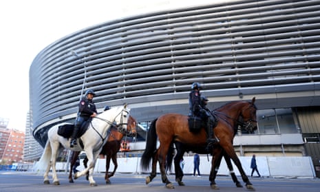 Police on horses are seen patrolling the outside of the Bernabéu stadium in Madrid.