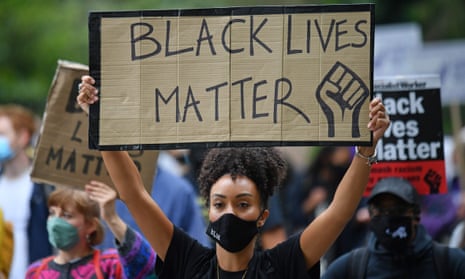 A protesters holds up a Black Lives Matter placard during the Million People March in London in August 2020