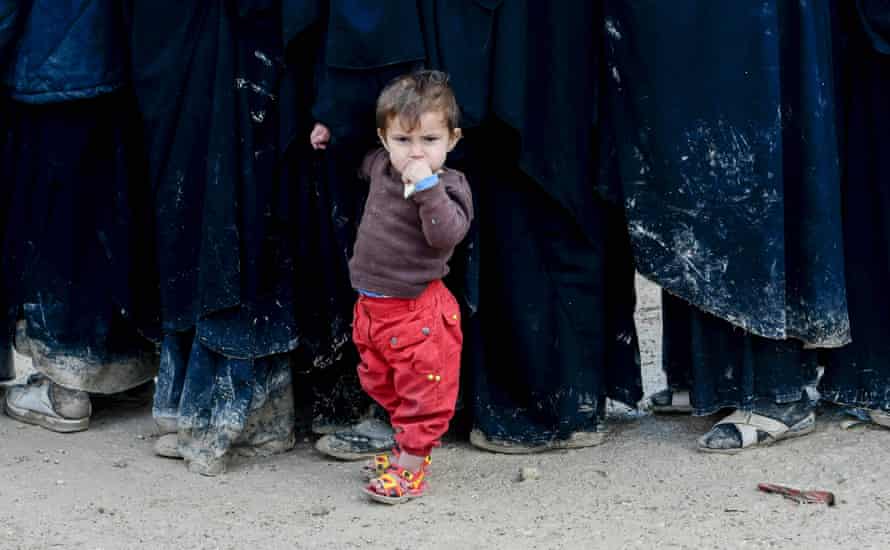 A child stands in queue in al-Hawll camp which houses relatives of Islamic State fighters in north-east Syria.