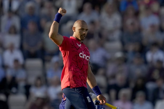 England's Tymal Mills celebrates winning the wicket against Indian Dinesh Karthik.