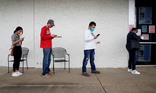 People wait in line to file for unemployment in Fayetteville, Arkansas, on 6 April. 