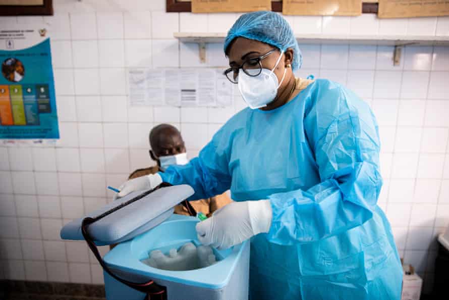 Mimi Henriette Mishika takes an AstraZeneca vial out of cold storage to begin the first vaccinations of the day at Kinshasa’s Clinique Ngaliema.