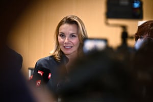 A woman talks to the press