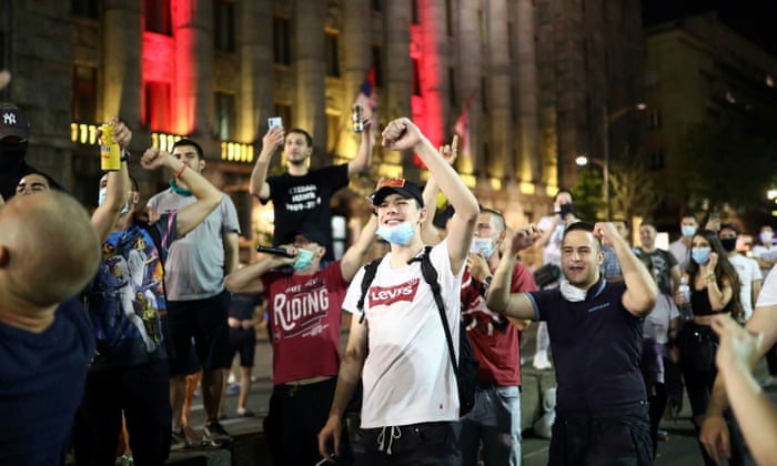 People sing after a rally against the government’s lockdown measures, amid the spread of coronavirus, in front of the parliament in Belgrade, Serbia.