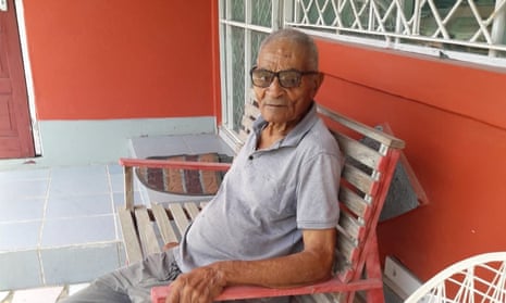 Philip Cato sitting outside a home in Jamaica