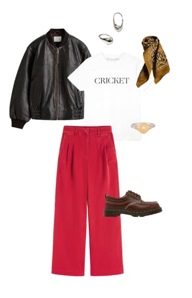 A composite image of a dark brown leather jacket, chunky silver hoop earrings, ochre printed neck scarf, white T-shirt with the word ‘Cricket’ on the front, gold and silver ring, red trousers and brown chunky lace-up shoes, all on a white background