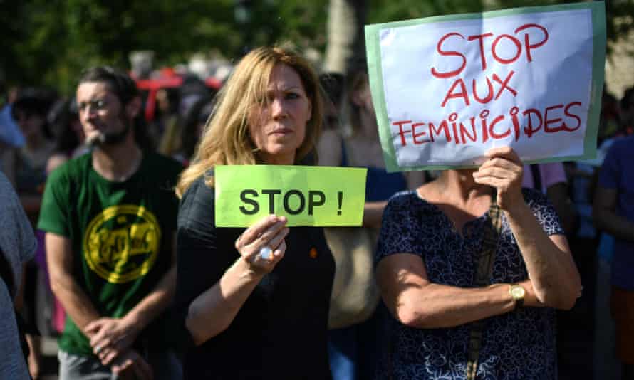 Women display signs during a demonstration against violence against women in Paris
