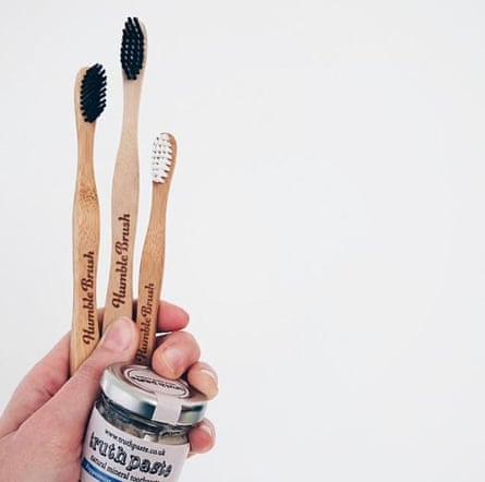 Bamboo toothbrush and toothpaste in glass