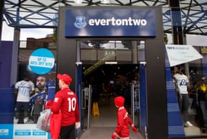 Liverpool fans pass by the Everton shop called 'Everton Two' in the Liverpool One shopping centre.