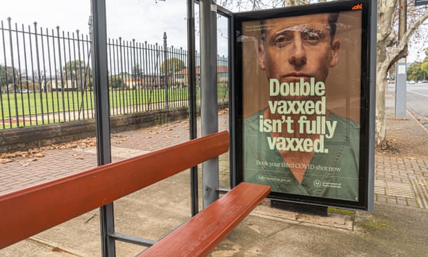 A South Australian government campaign poster on a bus shelter in Adelaide on 24 June urges people to get the Covid booster vaccine.