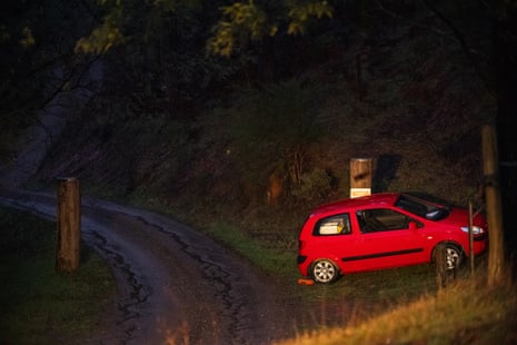 Red car beside driveway
