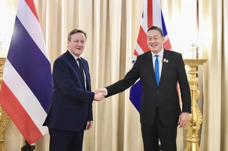 This handout photo taken and released on 20 March shows Thailand's prime minister Srettha Thavisin (R) shaking hands with Britain's foreign secretary David Cameron during a meeting at Government House in Bangkok.