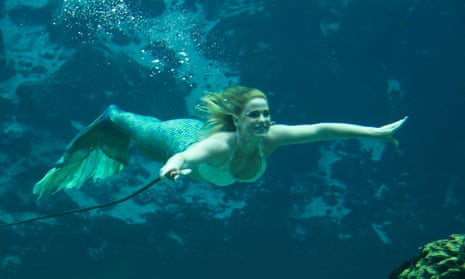 Fantasy mermaid in deep ocean shocked because water pollution