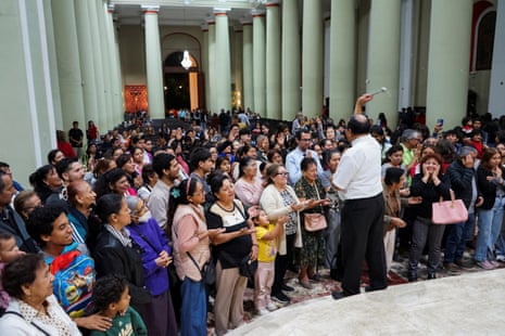 A priest sprays holy water on believers after mass at the Cathedral of Saint Mary in Chiclayo.