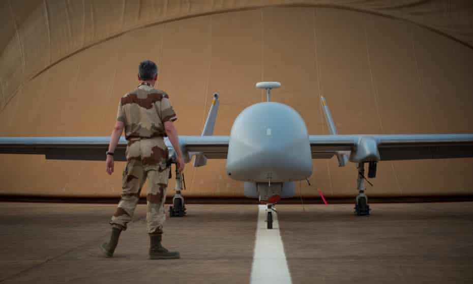 A French soldier of the Serval operation in Mali stands in front of a Harfang drone at the French army base in Niamey. 