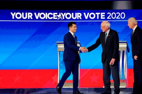 Pete Buttigieg shakes hands with Senator Bernie Sanders during the eighth Democratic primary debate of the 2020 presidential campaign season at St. Anselm College in Manchester, New Hampshire.