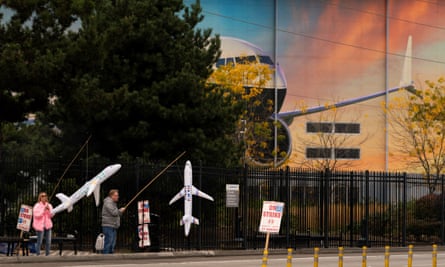 Striking Boeing workers hold inflatable airplanes on a picket line near the entrance to a Boeing production facility in Renton, Washington, US, 11 October 2024.
