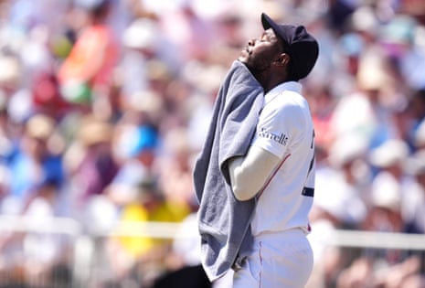 England's Jofra Archer wipes his face with a towel.