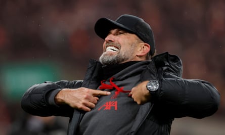 Klopp points to the club crest as he celebrates victory in the 2024 Carabao Cup final against Chelsea – his last trophy for the club.