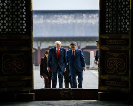 Trump and Xi Jinping walk towards a large entranceway