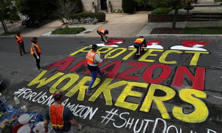 Activists paint a sign for Amazon.com Inc founder Jeff Bezos in Washington on 29 April 2020.