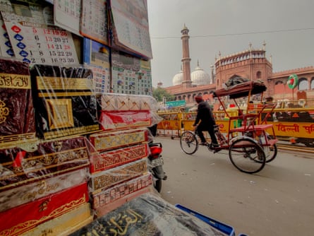 A view looking past a shop display out across the road to the wall of a huge and ornate mosque.