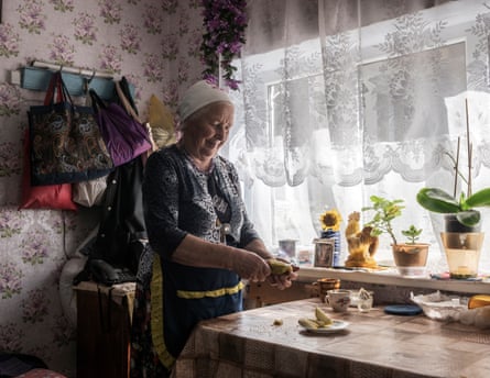 Varvara Dobish slices fruit at a table