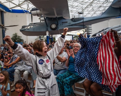 A boy celebrates the return of the Artemis II crew members to Earth at the San Diego Air and Space Museum