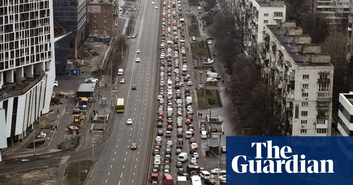Long lines of traffic as people flee Ukraine’s capital – video