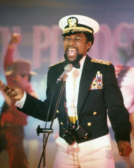 Victor Willis in a naval uniform singing on stage