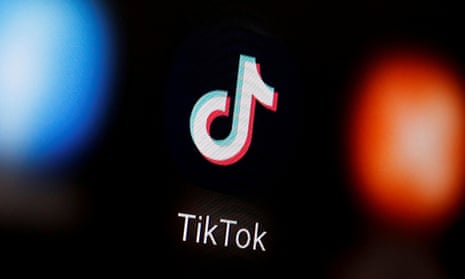 A TikTok logo displayed on a smartphone