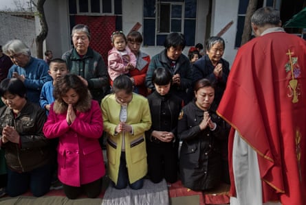 Catholics wait to take communion during the Palm Sunday mass at a ‘house church’ near Shijiazhuang.
