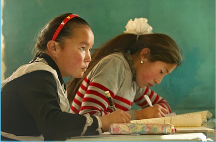 High-flier … Aisholpan, left, at her school studies; she wants to be a doctor.