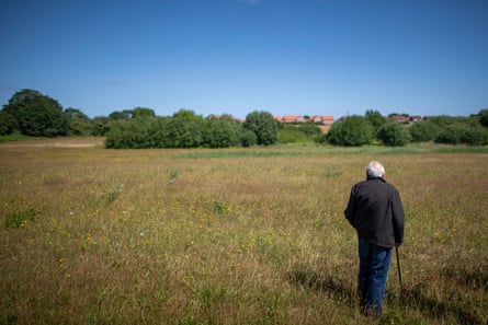 Derek Sayer stood in the recently mowed meadow
