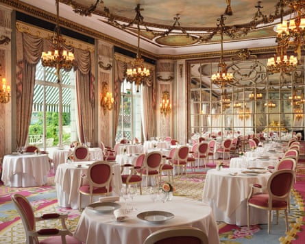 The interior of the Ritz restaurant, with chandeliers and tables topped with heavy white tablecloths
