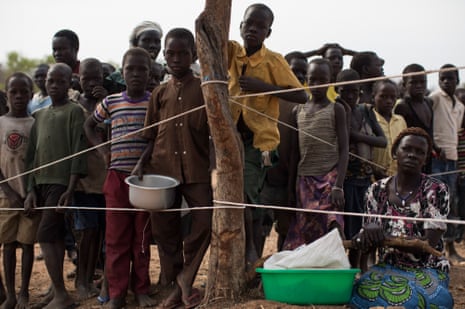 South Sudanese children wait as the WFP prepares to deliver food aid at the Bidi Bidi refugee camp in Arua, Uganda. 