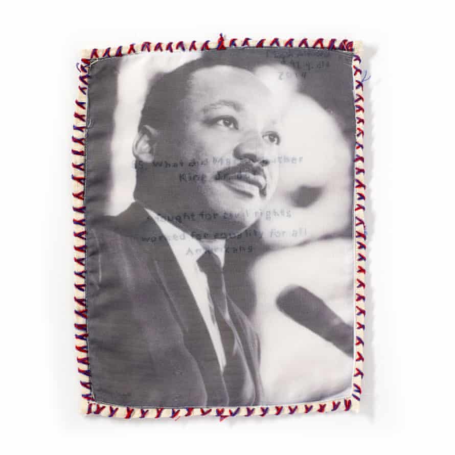 A rectangle of fabric is printed with the image of Martin Luther King Jr. In faint embroidery are the words: ‘55. What did Martin Luther King Jr do? - fought for civil rights, worked for equality for all Americans’. In the upper right is stitched: ‘Magali Almada, 42 y. old, 2014’.