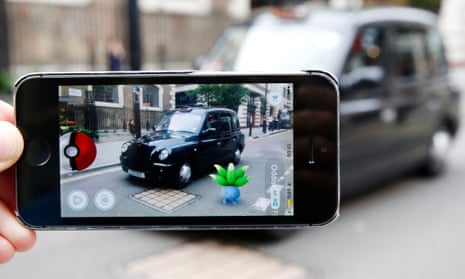 An oddish Pokemon character appears in front of a London taxi during a game of Pokemon Go
