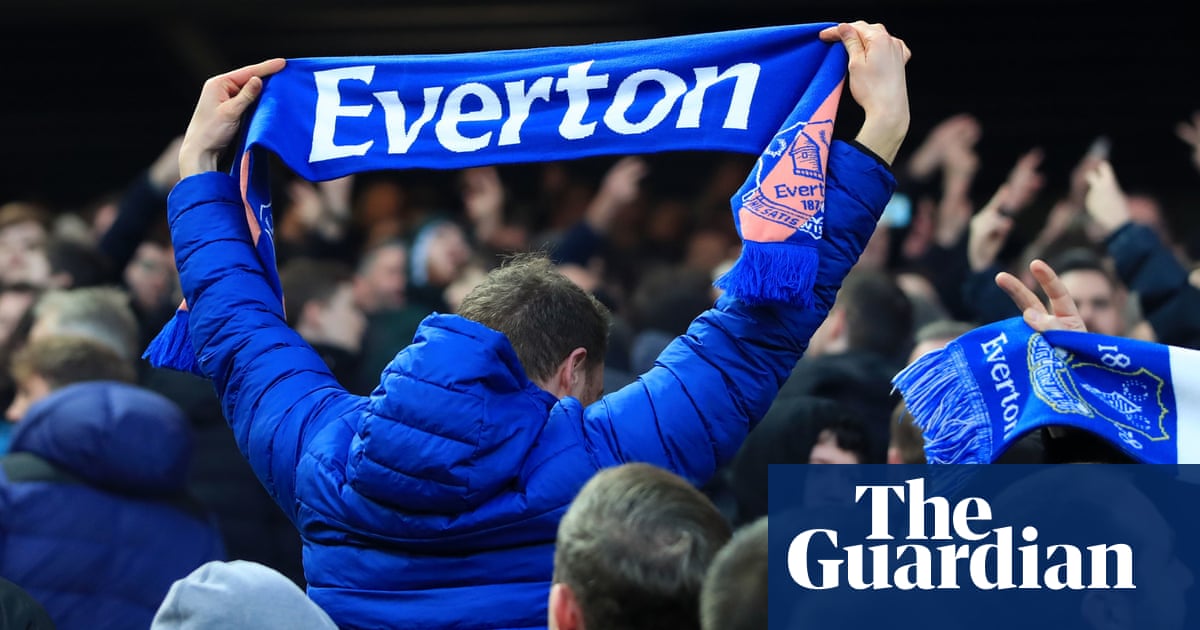 Everton director of football Marcel Brands wards off angry fans at training