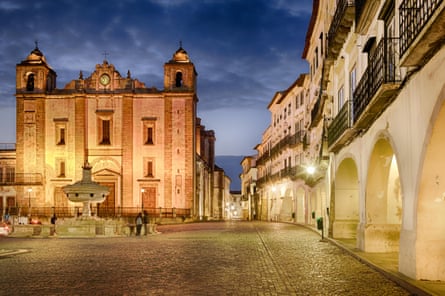 Iluminated church and old town at dusk