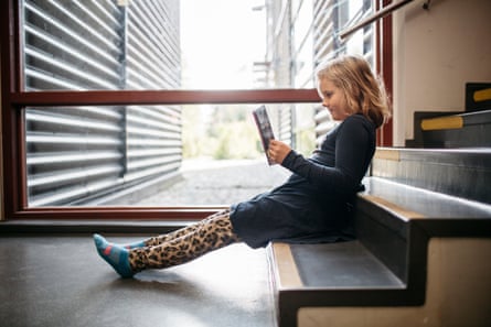 Second grader Menni Pietiläinen reads a book after official school hours.