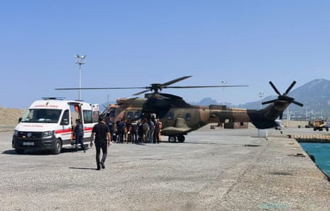 A helicopter brings survivors ashore after they were rescued from the sea after a passenger boat carrying more than 260 people capsized off northern Cyprus.