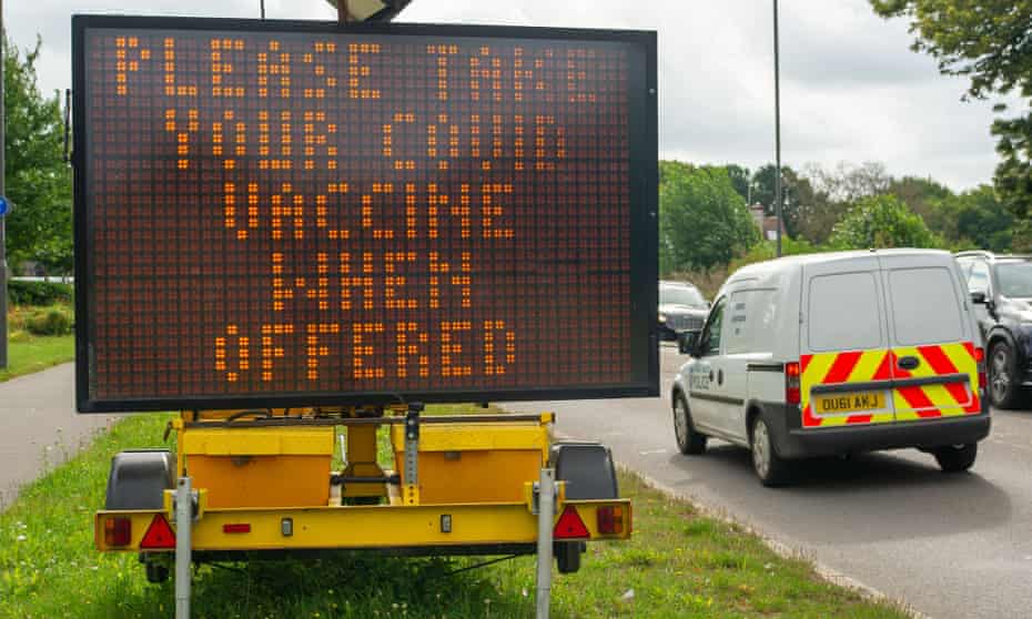 A roadside sign encouraging people to get vaccinated.