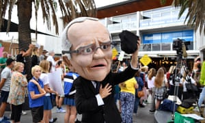 A protester dressed as Prime Minister Scott Morrison holding coal takes part in a rally on climate inaction outside the office of Prime Minister Scott Morrison in Cronulla, Australia, 3 May 2019.