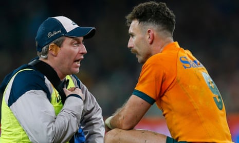 Nic White of Australia receives medical attention after a head injury