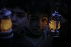 Idlib, Syria. Children hold donated hand lamps ahead of holy Islamic fasting month of Ramadan at a Al-Iman Refugee Camp
